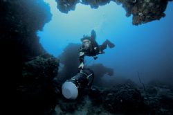 Tech diver and scooter exploring coral reefs , sodwanan s... by Andrew Woodburn 
